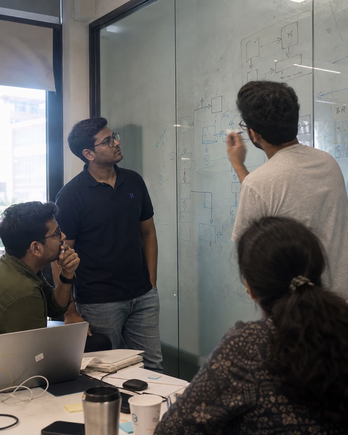 A representative architecture discussion at a glass board